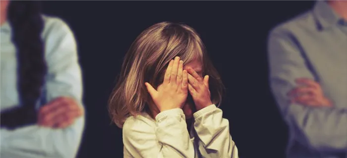 Девочка плачет, отвернувшись от родителей